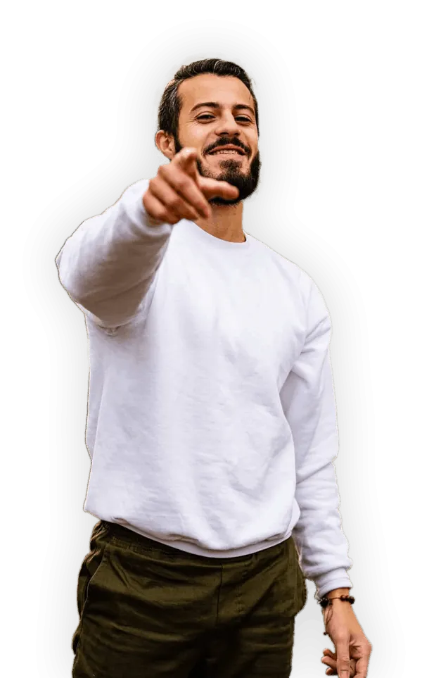 Alyaman Alhayek in a white sweatshirt, smiling and pointing toward the viewer