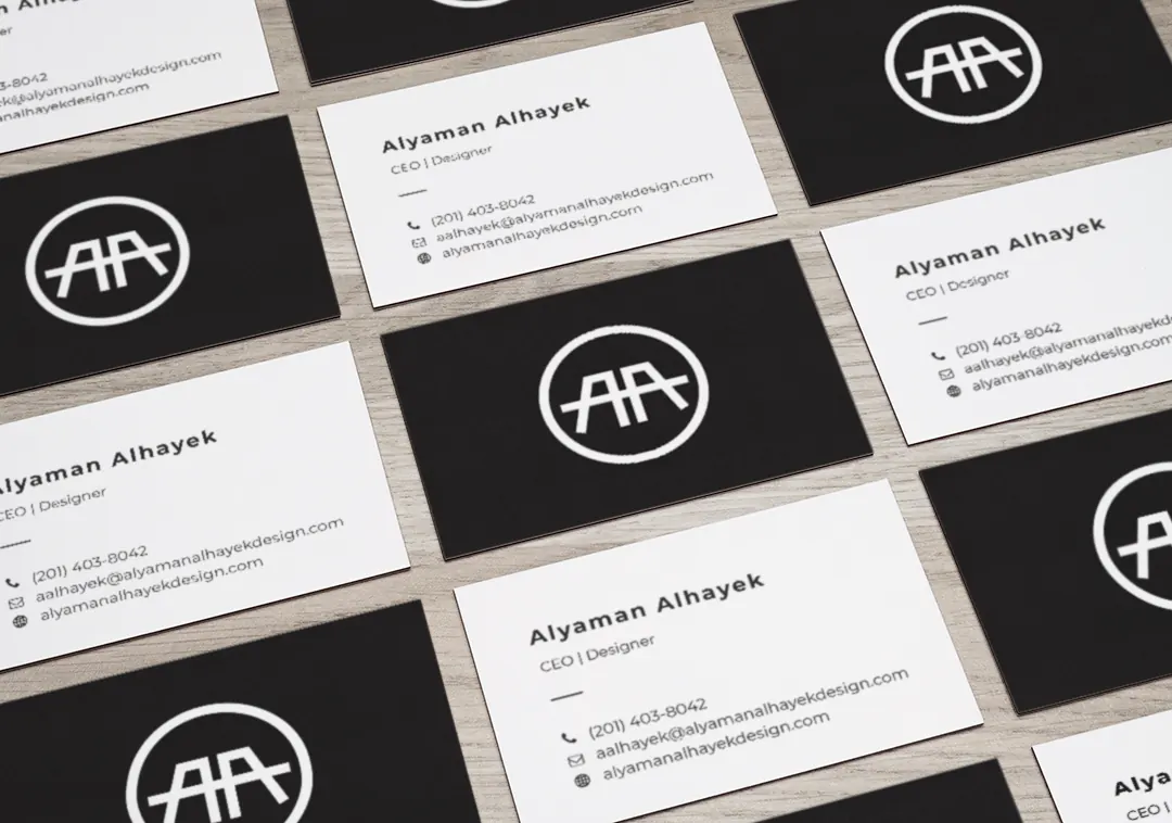 Rows of black and white business cards printed with the AA logo.