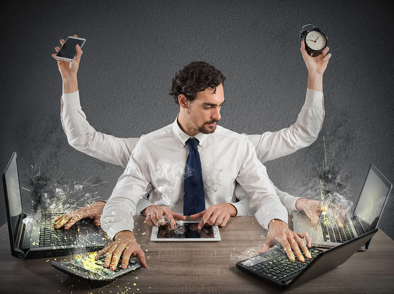 A businessman with many arms types, holds a phone and a clock at once.