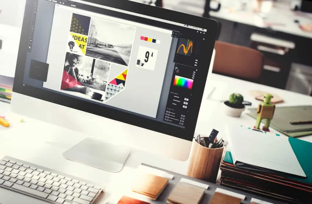 Design software with a magazine layout open on a desktop monitor.