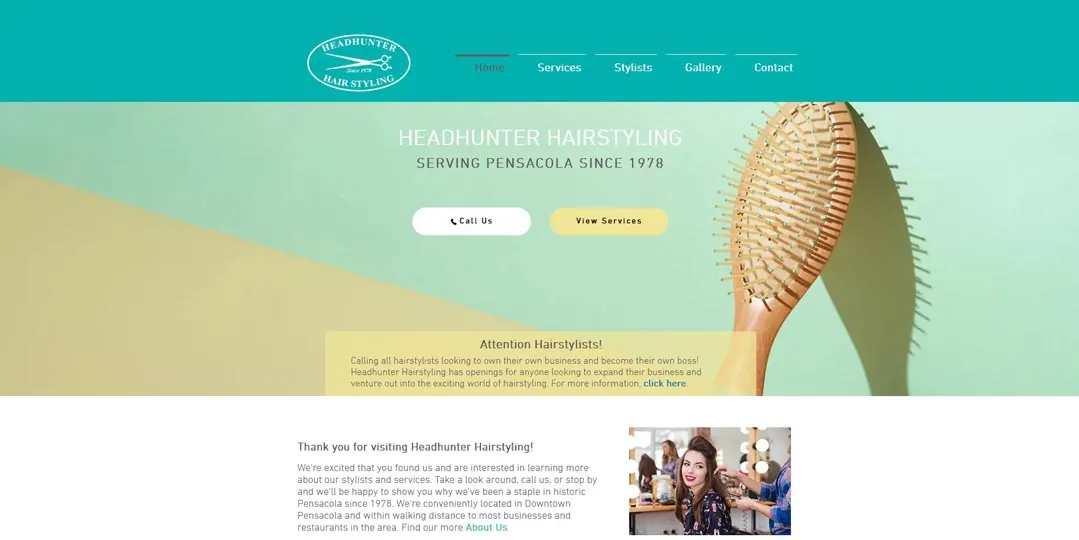 Screenshot of the Headhunter Hairstyling website with a hairbrush image.