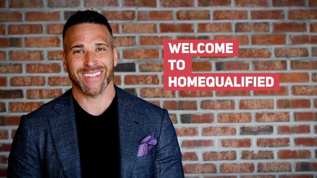 Smiling man in front of a brick wall with Welcome to HomeQualified text.