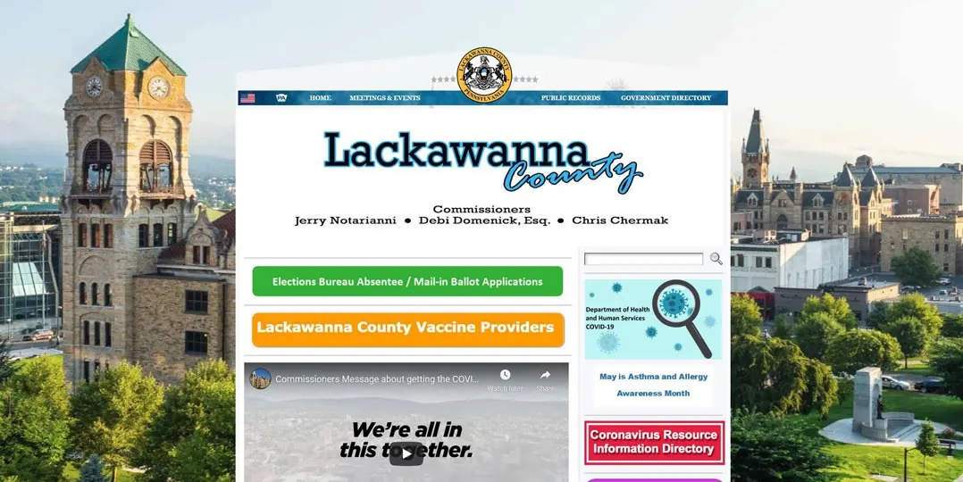 Screenshot of the Lackawanna County website over a photo of a clock tower.