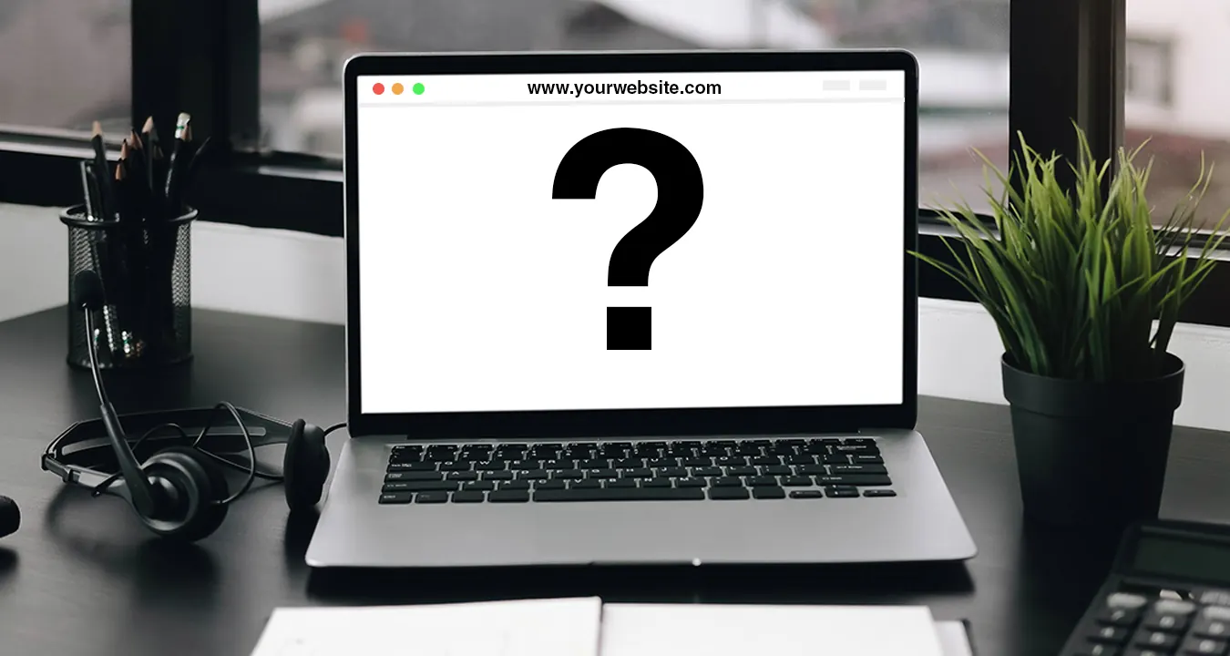A laptop on a desk shows a website with a large question mark.