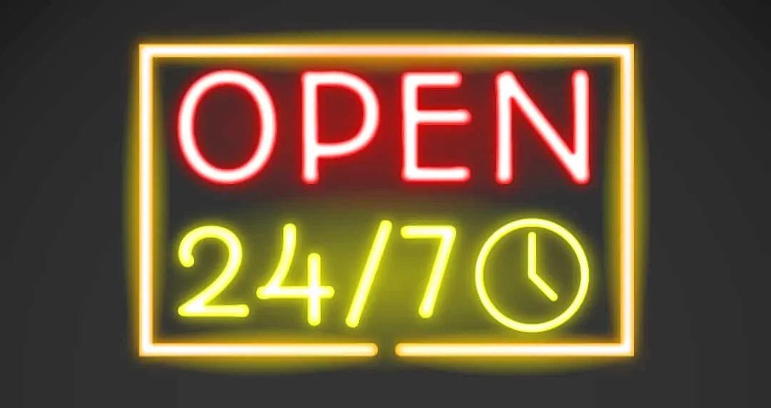 A glowing neon sign reading Open 24/7 with a clock icon.