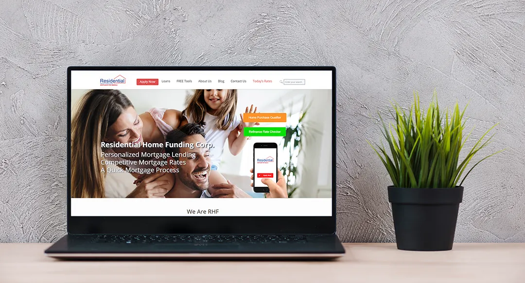 The Residential Home Funding website on a laptop beside a potted plant.