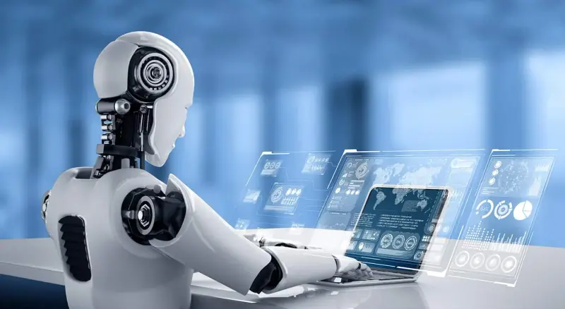A white humanoid robot uses a laptop with floating data screens.